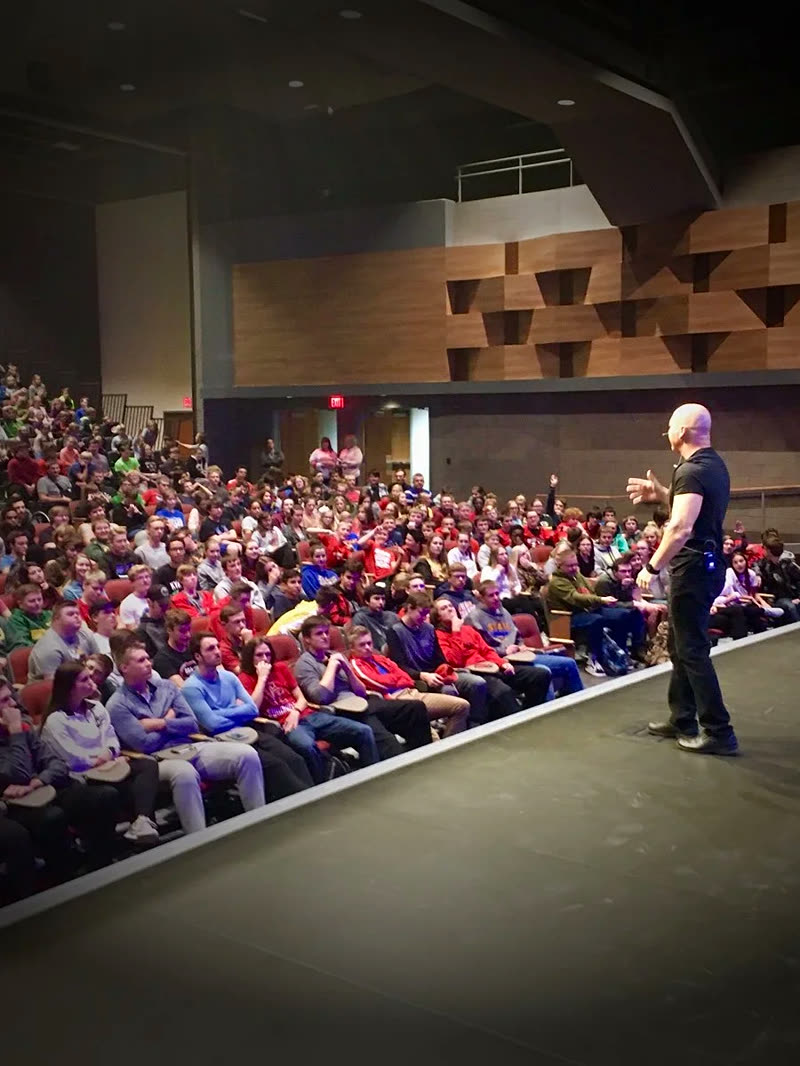 John James speaking to a school auditorium full of students